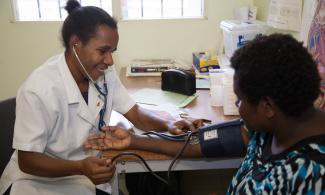 Doctor performs blood pressure check on a patient.