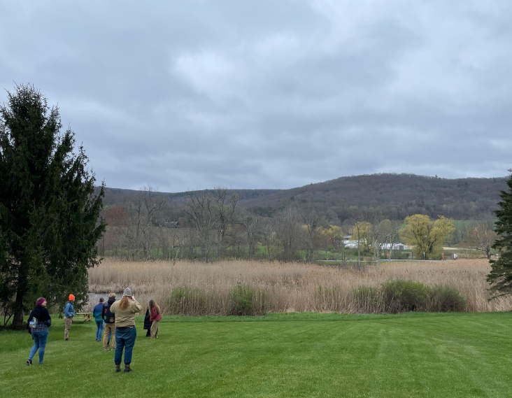 People standing in a grassy field.